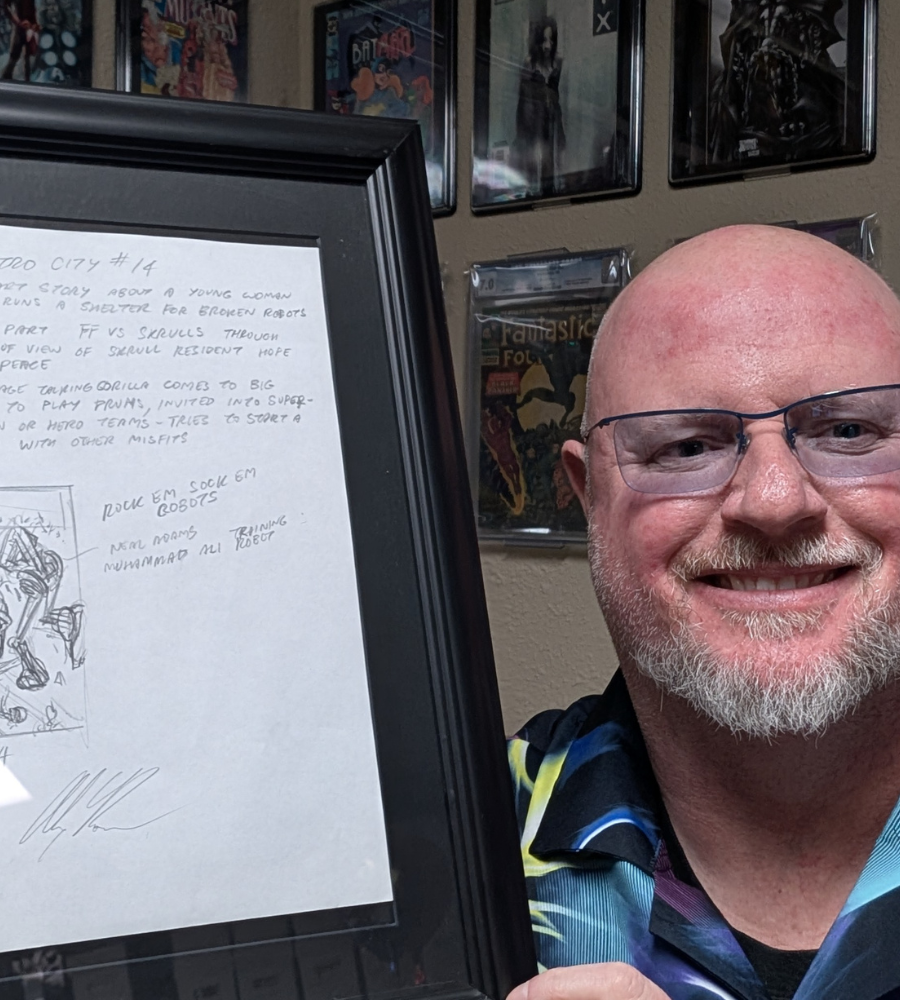 Collector's Club sketch winner showing their framed original Alex Ross sketch