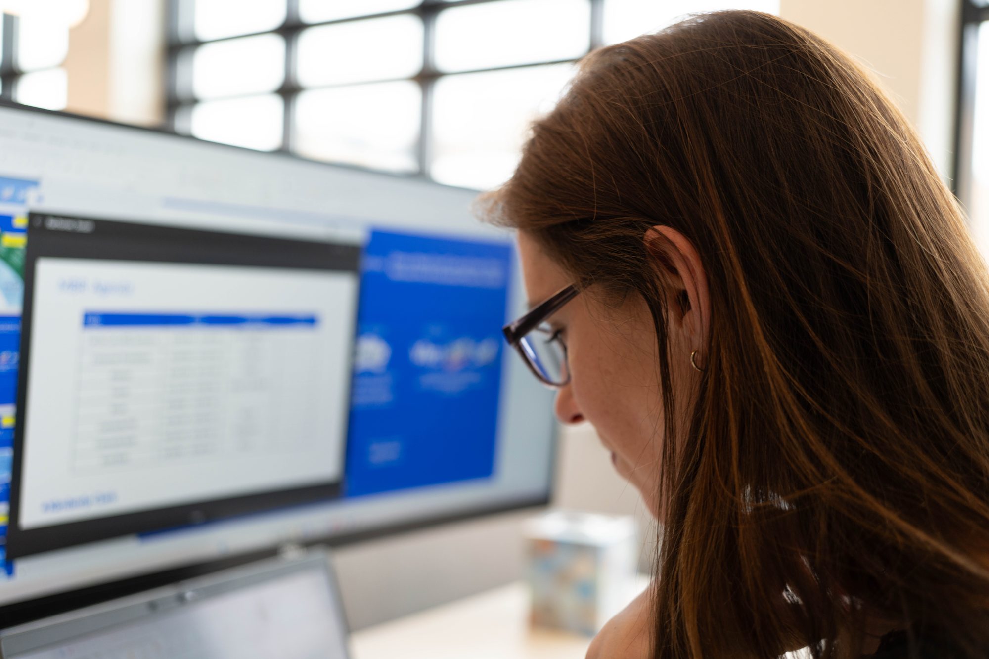 Modern open office with natural light and exposed ceiling