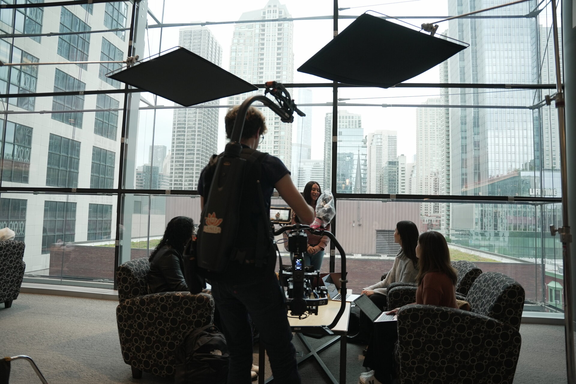 Lighting setup with Chicago skyline through glass atrium