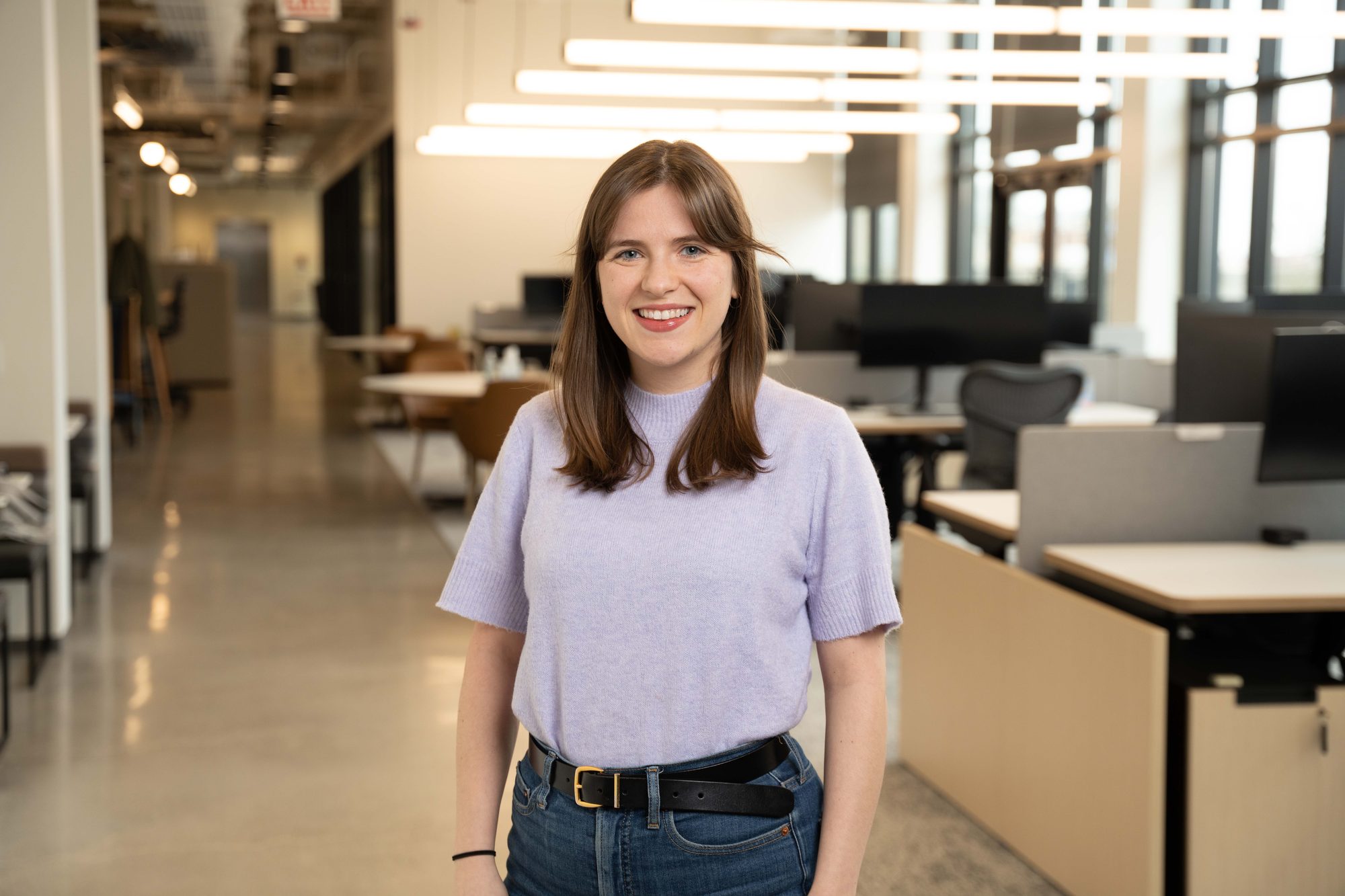 Employee walking through modern office corridor